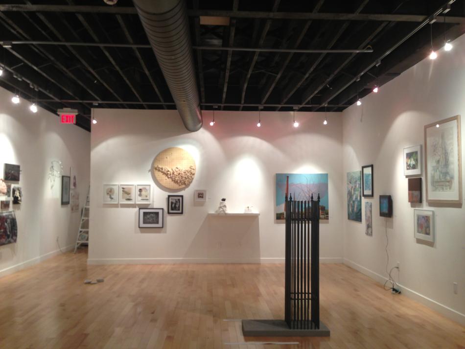 Wide shot of the gallery featuring a varity of artwork.