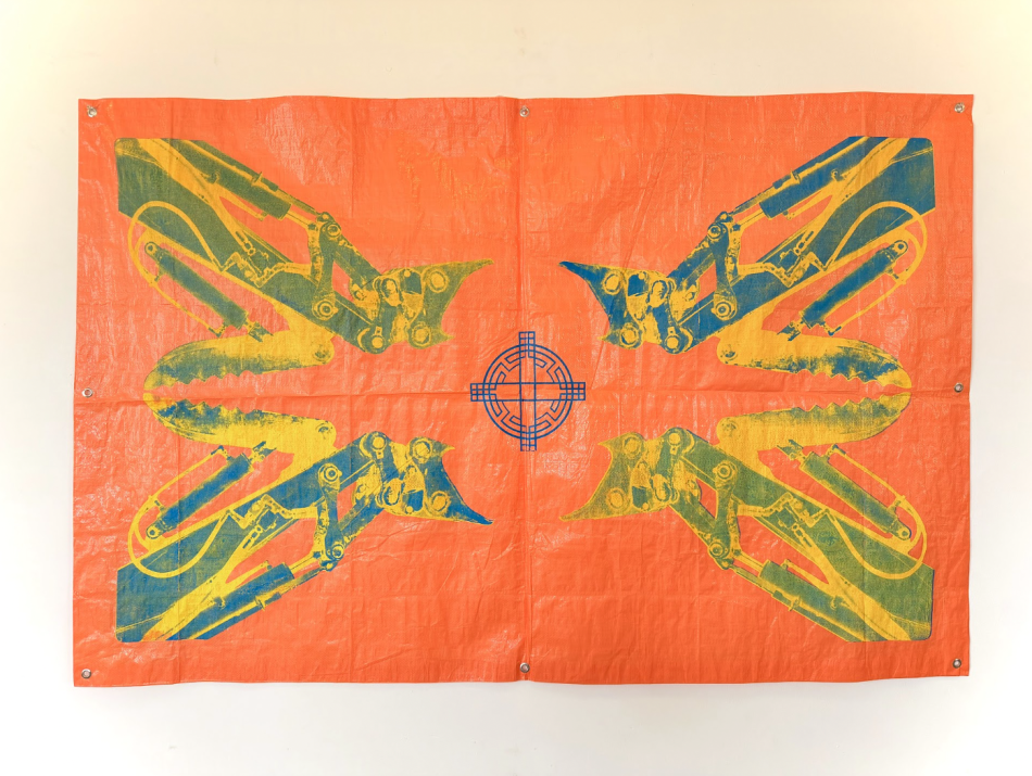A neon orange tarp that has prints in each corner in shades of yellow, green and blue. There is a blue, rounded symbol in the middle.